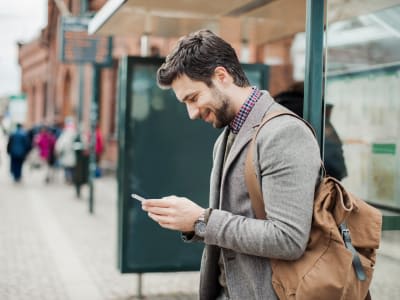 Businessman using smart phone at bus station Resume World - Technical/IT/Eng. Resumes